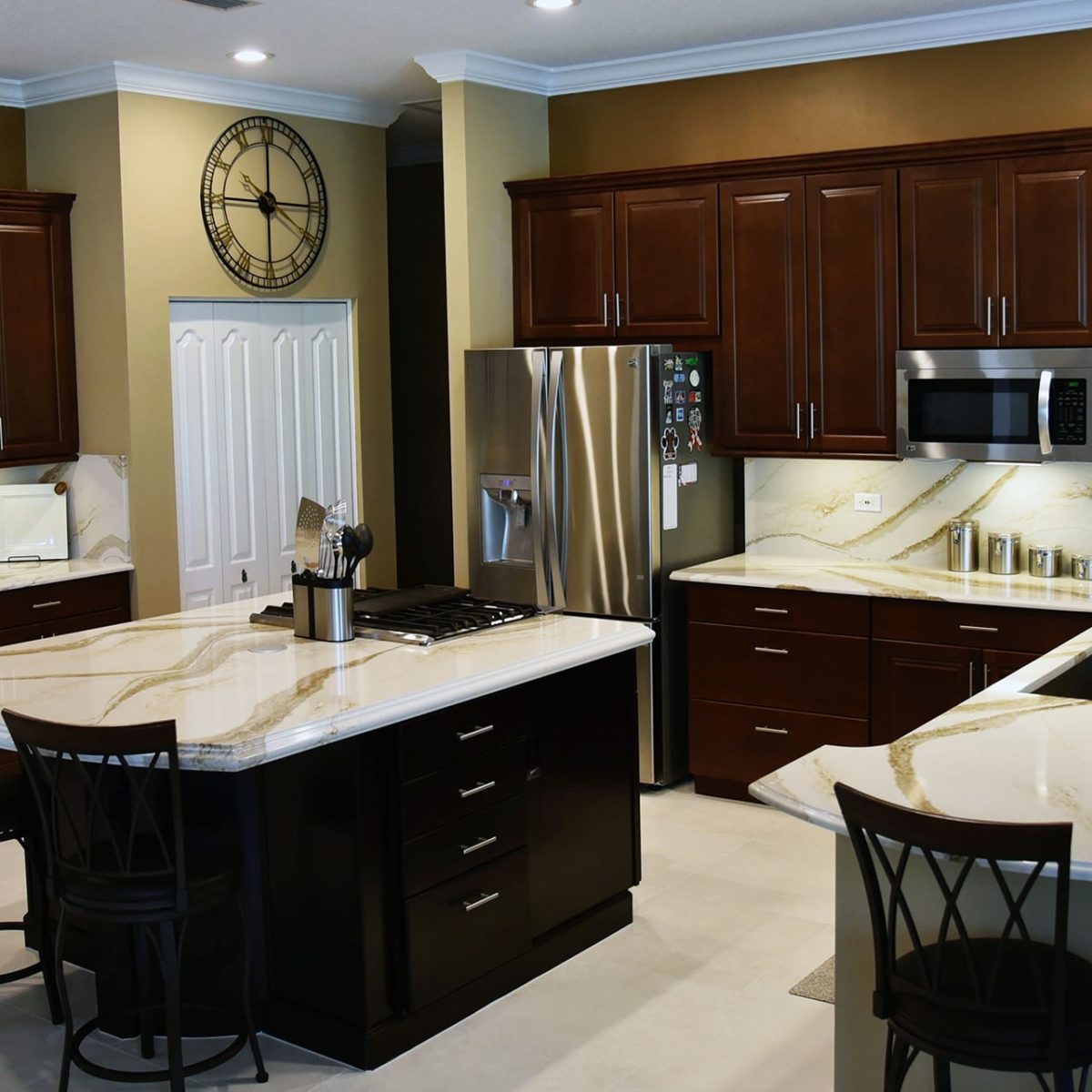 Fitzgerald Brittanicca Gold Cambria Quartz Countertops in Kitchen with Backsplash and Dark Wood Cabinets