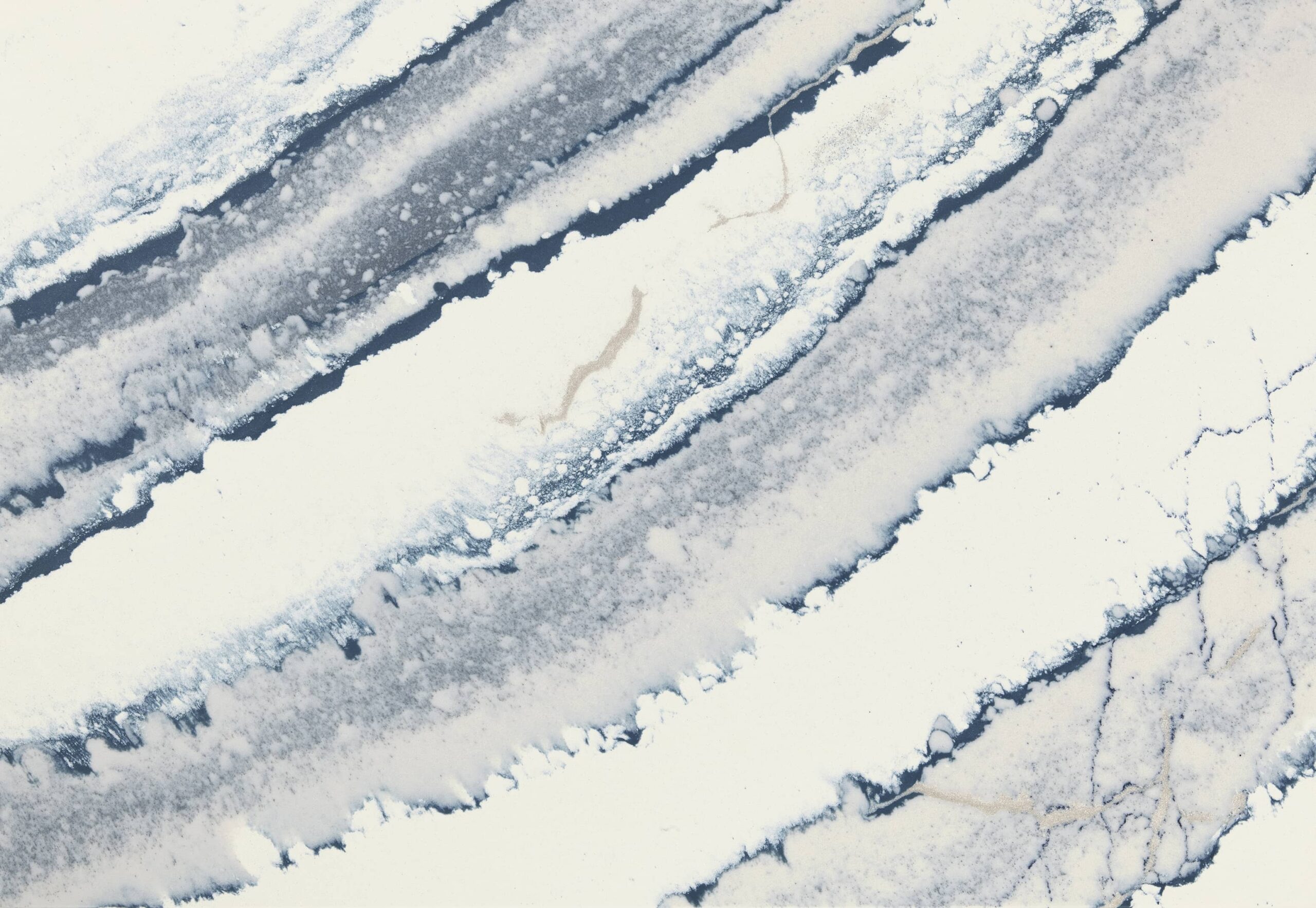 Close-up view of Cambria Inverness Bristol Bay Quartz countertop featuring stormy-blue waves, cool white backdrop, and debossed Inverness veins, showcasing its high gloss finish and durability for residential and commercial applications.