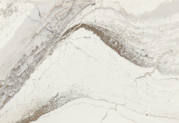 Windsor Brass Satin Ridge by Cambria Quartz: Experience the pinnacle of luxury and timeless elegance with this exquisite quartz surface. The design intricately blends rich chocolate brown tones with warm honey hues, all set against a textured canvas of debossed Inverness veins. Glistening brass elements meander across the surface, adding nuanced warmth, fluidity, and an unparalleled sheen. Offered in expansive jumbo slab sizes, this design is the ideal choice for creating lavish countertops, striking feature walls, and standout islands.