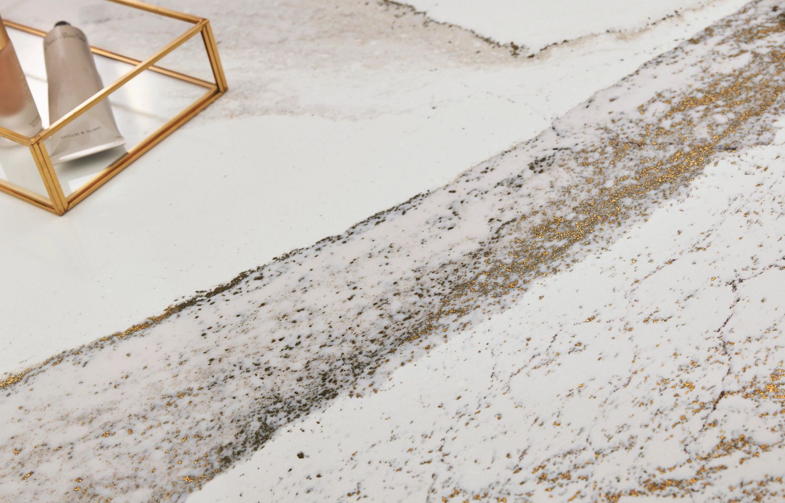 Close-up view of rich brown currents flowing against a crisp white background, accented by subtle flashes of radiant brass in Cambria Windsor Brass Quartz design
