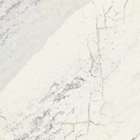 Close-up view of Cambria Windsor Steel Satin Ridge Quartz, showcasing its steel-toned wave patterns, warm honey-colored sand backdrop, and contrasting cool charcoal elements.