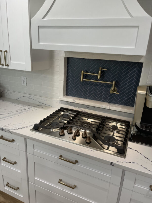 Portrush Cambria Quartz Kitchen Countertops with White Cabinets with Blue Tile Backsplash