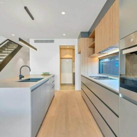 modern minimalist kitchen remodel with white cabinets wood accents kitchen island and built in appliances