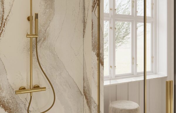 view of rich brown currents flowing against a crisp white background, accented by subtle flashes of radiant brass in Cambria Windsor Brass Quartz design installed on shower walls
